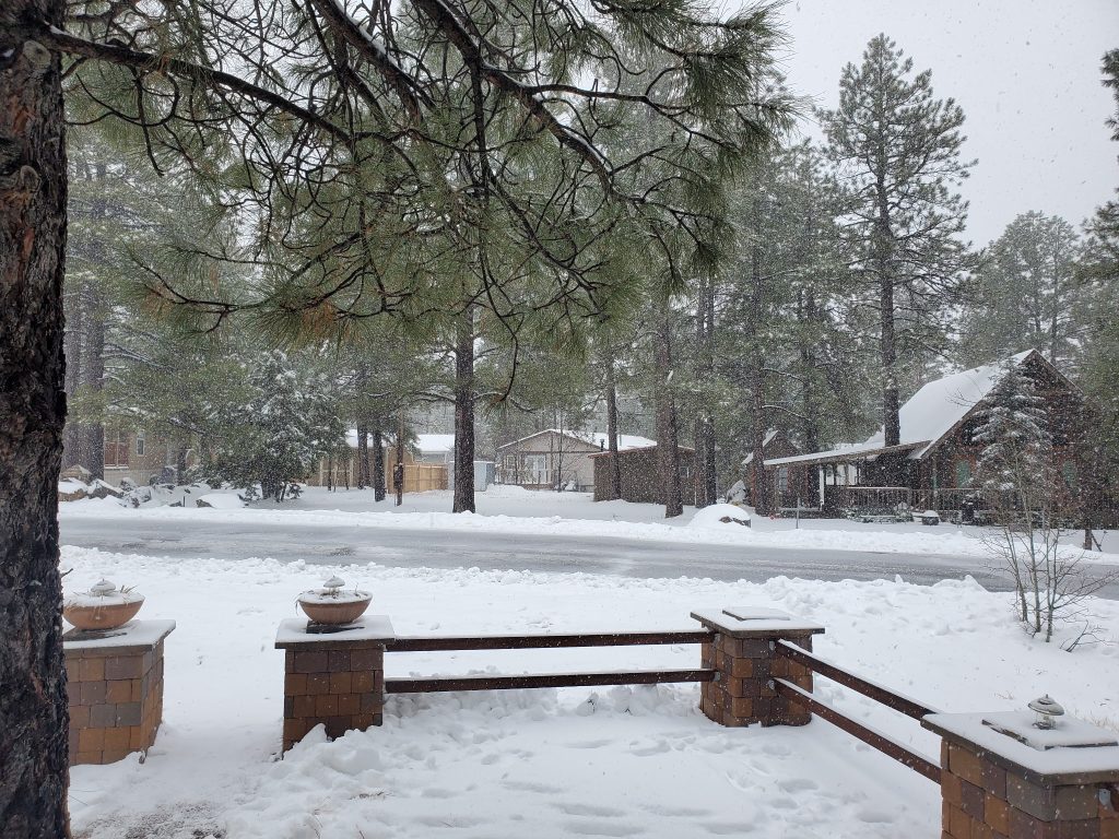 Fresh snow falling in Munds Park, Arizona, viewed from the front yard of Deer Run Retreat